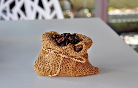 Coffee beans roasted in the small sack with bokeh backgroundの写真素材