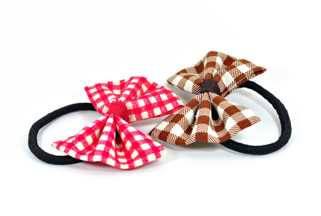 Two rubber bands with bow on white background の写真素材