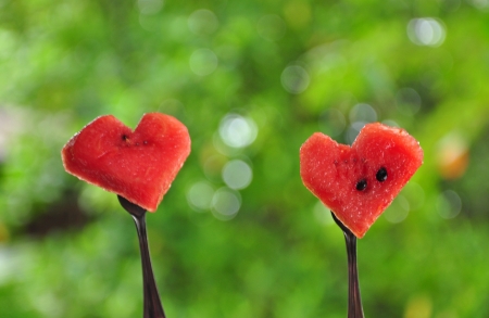 Two stainless steel forks with watermelon heart  Concept about love の写真素材