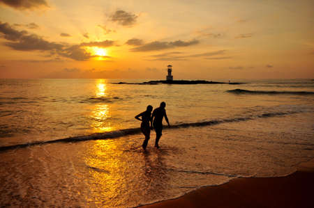 Silhouette romantic scene of couples on the beach with sunset Concept about love and relationshipの写真素材