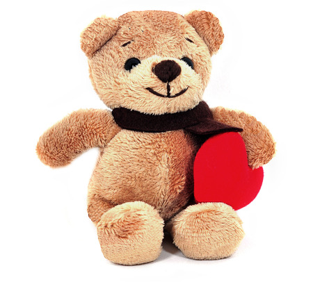 Teddy Bear holding a heart on white background の写真素材