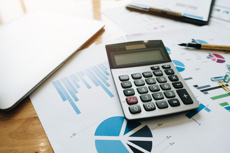 Calculator pen and laptop on workspace, Professional marketing and financial desk in office , laptop paperwork and pen on table , Office Conceptの写真素材