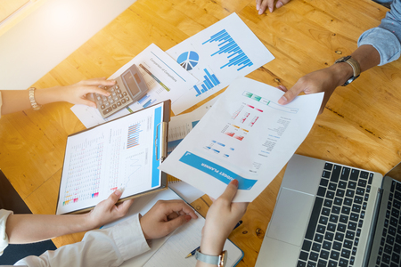 Professional investor and financial meeting present time. Young business team working with new startup project in office room present marketing strategies plan with coffee cup, Office Conceptの写真素材