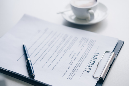 Pen on contract sheet and business document ,near coffee cup in home office, Business and Office concept.の写真素材