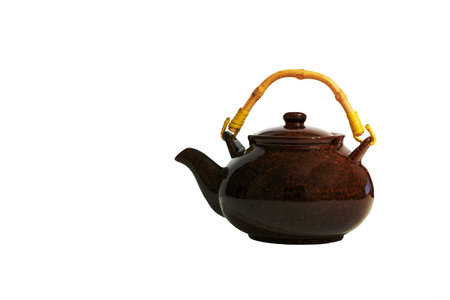 brown porcelain teapot with yellow handle isolated on white backgroundの写真素材