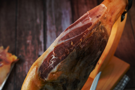 spanish acorn-fed iberian ham close-up open knife cutの写真素材