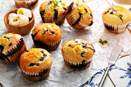 Blueberry muffins with fresh berries and blueberry preserves served with butterの写真素材