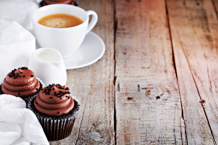 Chocolate cupcakes with a cup of hot black coffeeの写真素材