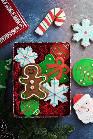 Christmas sugar and gingerbread cookies decorated with royal icing in a box or tin