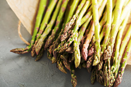 Fresh green raw asparagus stalks on the tableの写真素材