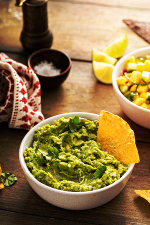 Homemade guacamole freshly made with tortilla chipsの写真素材