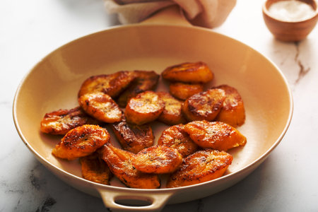 Fried caramelized plantains in a cast iron panの写真素材