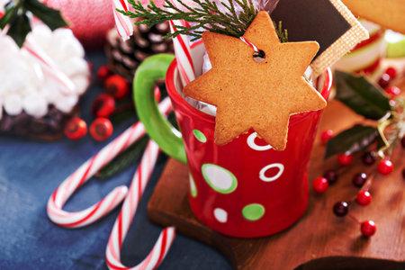 Hot cocoa mug with gingerbread cookie and gift package for Christmas