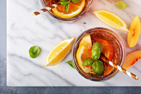 Peach and lemon sweet iced tea on a marble surface overhead shotの写真素材