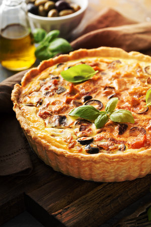 Homemade quiche with chicken and caponata made from eggplant and olivesの写真素材