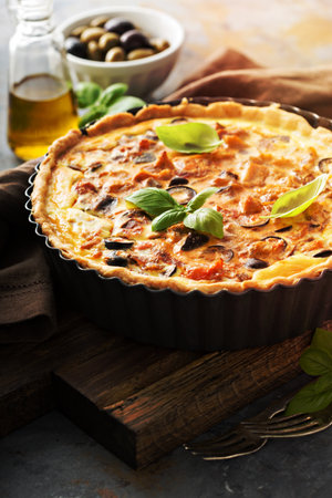 Homemade quiche with chicken and caponata made from eggplant and olivesの写真素材