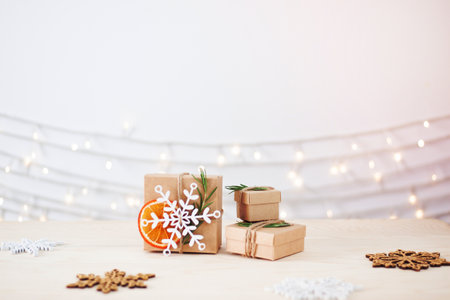 Eco friendly packaging gifts in craft paper on wooden table. Zero waste Christmas holiday concept. Close up, copy spaceの写真素材