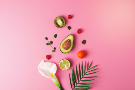 Summer fruit composition. Creative tropical background made from fresh fruits and palm leaves on...