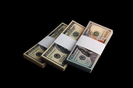 Bundle of US dollar bills isolated on black. Pack of american money with high resolution on perfect black background as object for designの写真素材