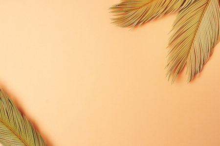 Tropical background with palm leaf on pastel beige. Flat lay, copy spaceの写真素材