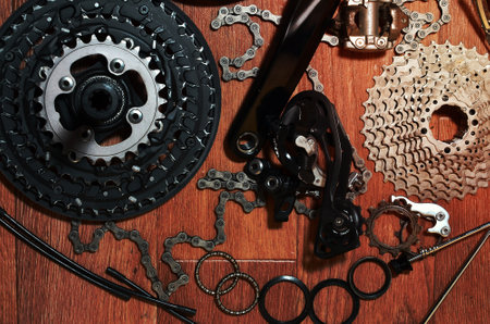 Many different metal parts and components of the running gear of a sports bike. Brake levers,...
