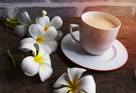 Cup of tea with milk on wooden backgroundの写真素材
