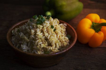 Organic Brown Rice in the bowl on the wooden tableの写真素材