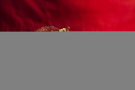 red christmas ball on the red paper.