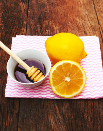 Tea with lemon and honey on the wooden background.の写真素材