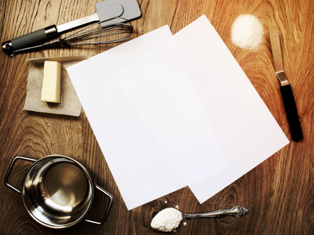 Blank copy paper sheets on wooden table background with baking tools and ingredients aroundの写真素材
