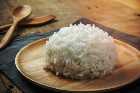 Close-up view of cooked white rice with napery and wooden spoon - soft focusの写真素材