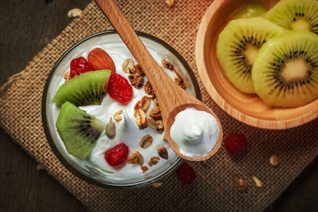 Greek yogurt with kiwi - on wooden backgroundの写真素材