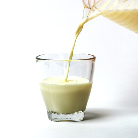 Pouring a cup of milk creating splashの写真素材