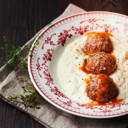 Meatballs, duck meat, with apple sauce and mashed celery, potato on a wooden background.の写真素材