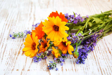 bouquet of calendula and lavender  flowers on a wooden backgroundの写真素材