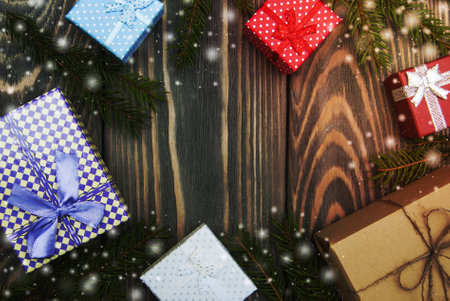 christmas trees with heap of gift boxes on a wooden backgroundの写真素材