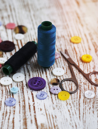 threads, measuring tape on a satin background