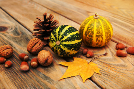 autumn pumpkins with leaves on a wooden backgroundの写真素材