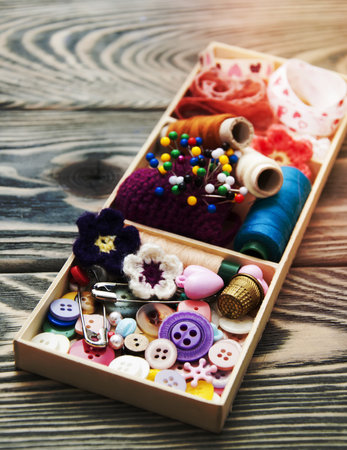 thread and material for handicrafts in box on a wooden backgroundの写真素材