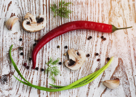 chilis,  onion,  mushrooms and garlic  on wooden tableの写真素材