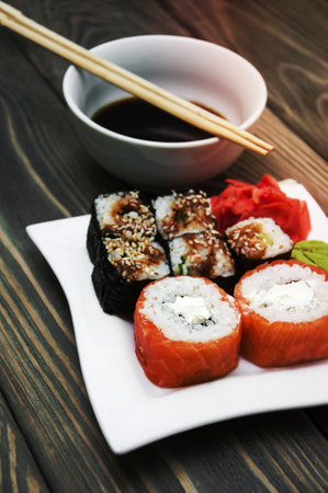 Plate with rolls, wasabi and ginger on a wooden backgroundの写真素材