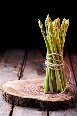 Bunch of fresh asparagus on a wooden backgroundの写真素材