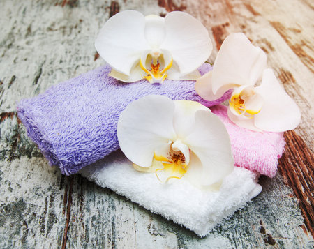 spa still life - a flower and towels on a wooden backgroundの写真素材