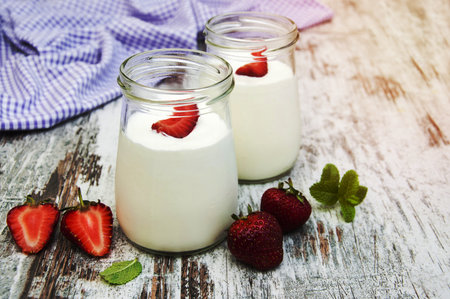 Strawberry fruit yogurt with fresh strawberries on a old wooden backgroundの写真素材