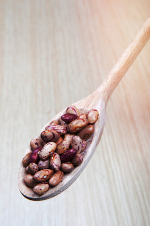 beans on a wooden spoon
