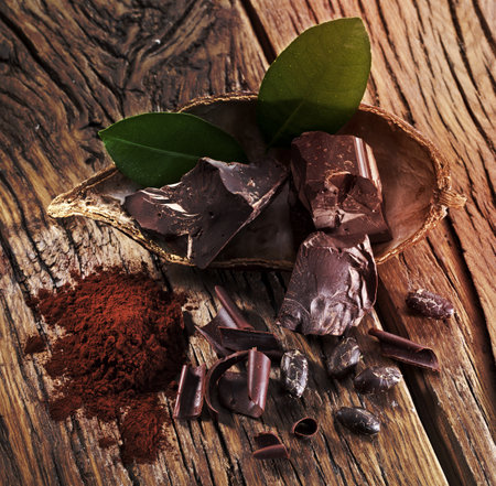 Chocolate and cocoa bean over wooden table.の写真素材
