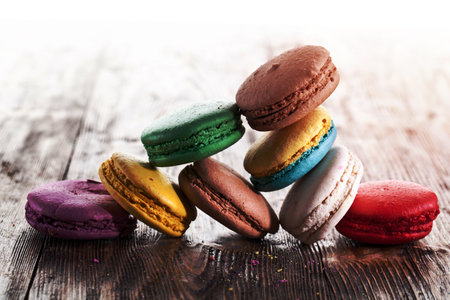 Colourful french macaron on an old wooden table.の写真素材