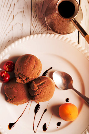 Chocolate ice cream with cherry and apricotの写真素材