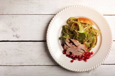 Pasta tagliatelle with roasted duck breast and vegetablesの写真素材