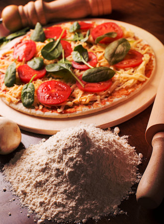 Raw Italian pizza with sausages and mushroomsの写真素材